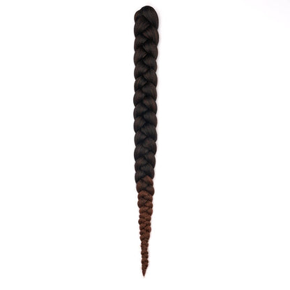 A length of braided hair in ombré black to brown on a white field.